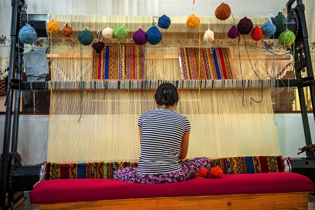 Woman working at the manufacture of carpets, on May 17, 2013, in Cappadocia, Turkey. Turkish rugs are one of the main economic sectors of the country.